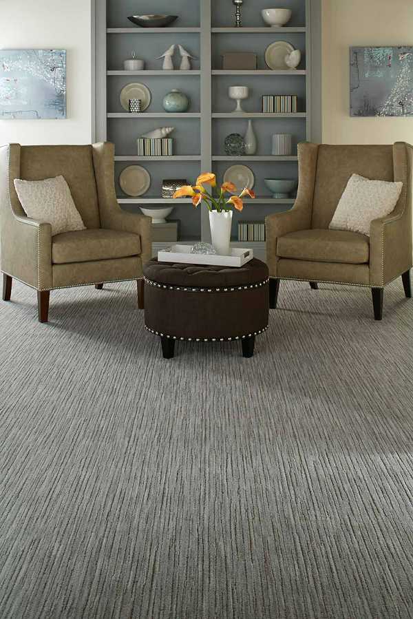 transitional sitting area with gray carpet and wingback chairs